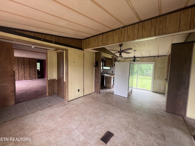 1311 Old Union Rd, Hilham, TN 38568 - unfurnished living room with wooden walls and a ceiling fan