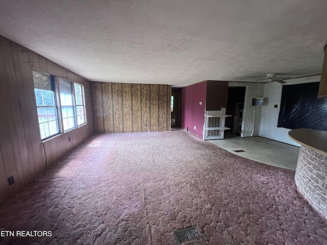 1311 Old Union Rd, Hilham, TN 38568 - carpeted empty room with wood walls, a textured ceiling, and a ceiling fan