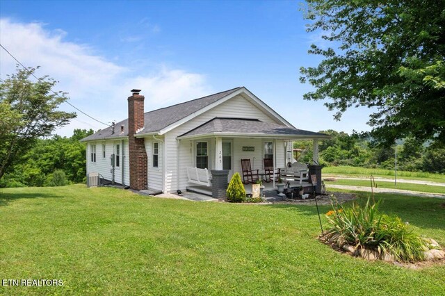 245 Lake Shore Ln, Lafollette, TN 37766 - rear view of property featuring a chimney, a porch, and a lawn