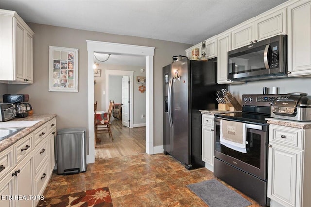 245 Lake Shore Ln, Lafollette, TN 37766 - kitchen featuring appliances with stainless steel finishes and stone finish flooring