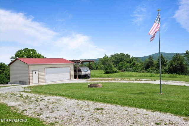 245 Lake Shore Ln, Lafollette, TN 37766 - garage featuring a garage, driveway, and a mountain view