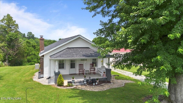 245 Lake Shore Ln, Lafollette, TN 37766 - view of front of home with a porch, a front lawn, a chimney, and roof with shingles