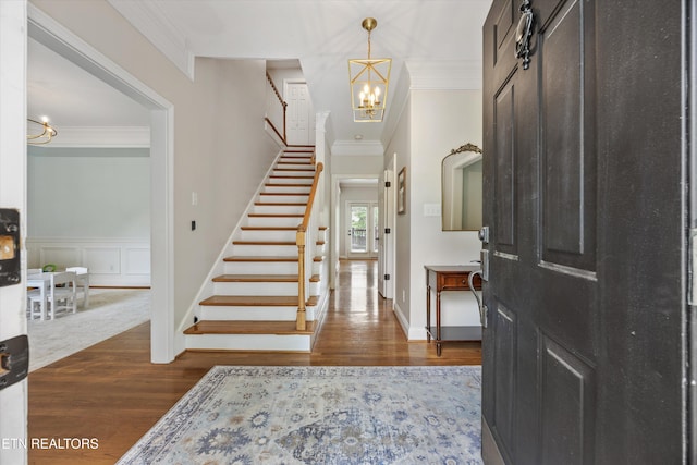 11919 Burnside Pl, Knoxville, TN 37934 - foyer with a chandelier, stairway, ornamental molding, dark wood finished floors, and wainscoting
