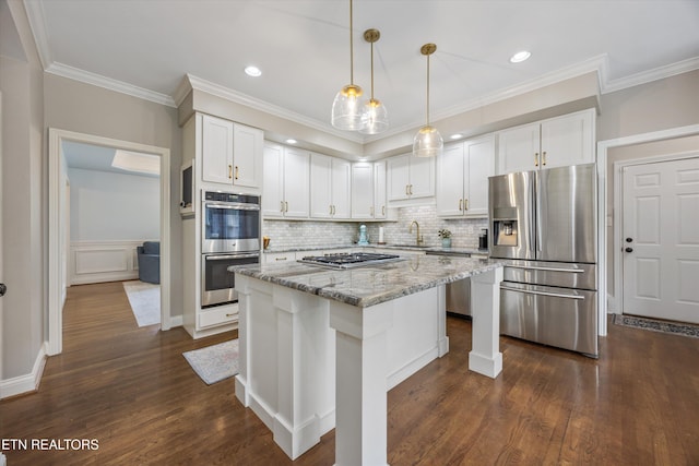 11919 Burnside Pl, Knoxville, TN 37934 - kitchen with appliances with stainless steel finishes, white cabinetry, light stone countertops, a center island, and dark wood-style floors