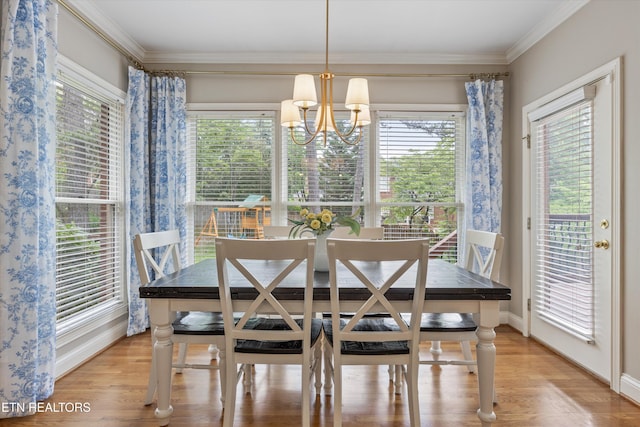 11919 Burnside Pl, Knoxville, TN 37934 - dining area featuring healthy amount of natural light, baseboards, ornamental molding, light wood finished floors, and a chandelier