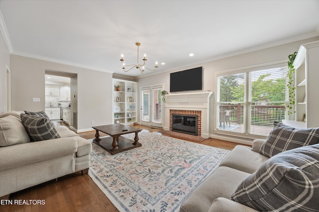 11919 Burnside Pl, Knoxville, TN 37934 - living room with a chandelier, crown molding, dark wood-style floors, baseboards, and recessed lighting