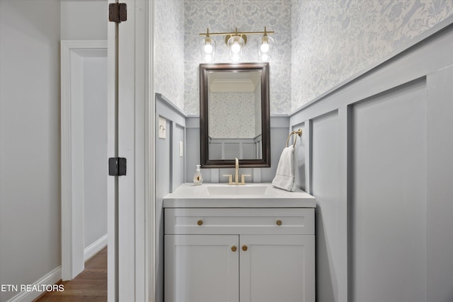 11919 Burnside Pl, Knoxville, TN 37934 - bathroom featuring wallpapered walls, vanity, and wood finished floors