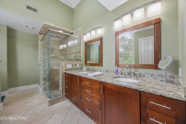 11919 Burnside Pl, Knoxville, TN 37934 - bathroom featuring double vanity, a shower stall, tile patterned floors, and crown molding