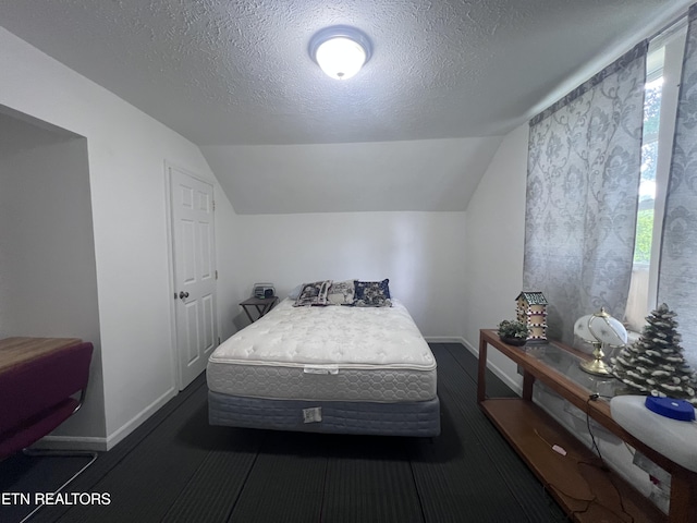 151 Davis Rd, Sneedville, TN 37869 - bedroom featuring vaulted ceiling, baseboards, and a textured ceiling
