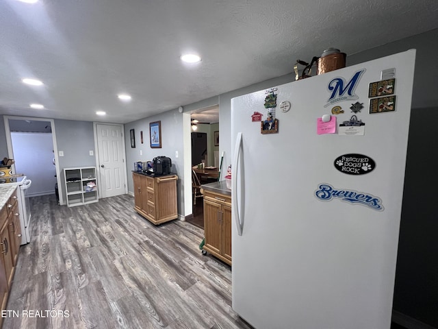 151 Davis Rd, Sneedville, TN 37869 - kitchen with white appliances, wood finished floors, recessed lighting, brown cabinets, and a ceiling fan