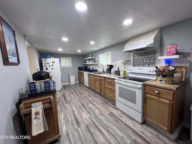 151 Davis Rd, Sneedville, TN 37869 - kitchen with white appliances, a sink, light wood finished floors, recessed lighting, and brown cabinetry