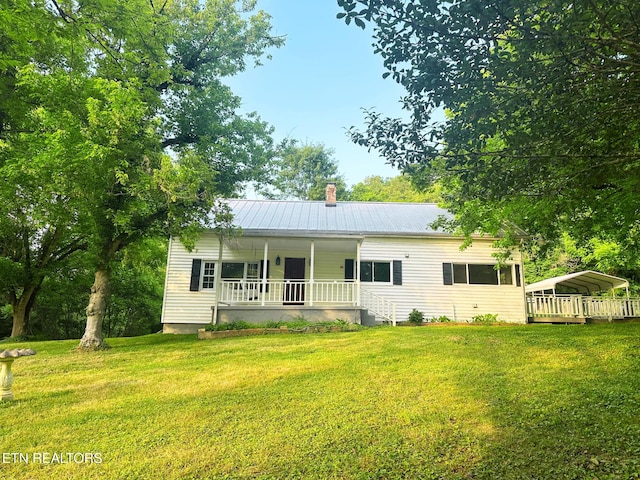 5936 Thorn Grove Pike, Knoxville, TN 37914 - rear view of house featuring a porch, a lawn, a detached carport, and a metal roof