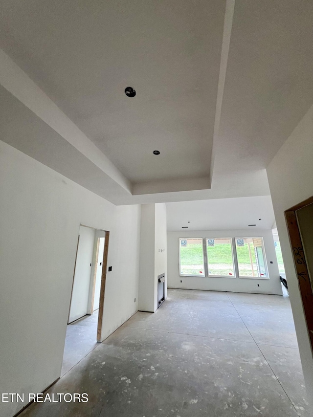 254 Walelu Trl, Vonore, TN 37885 - unfurnished living room featuring a raised ceiling