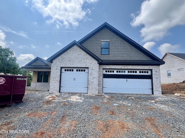 254 Walelu Trl, Vonore, TN 37885 - craftsman-style house with driveway, brick siding, and an attached garage