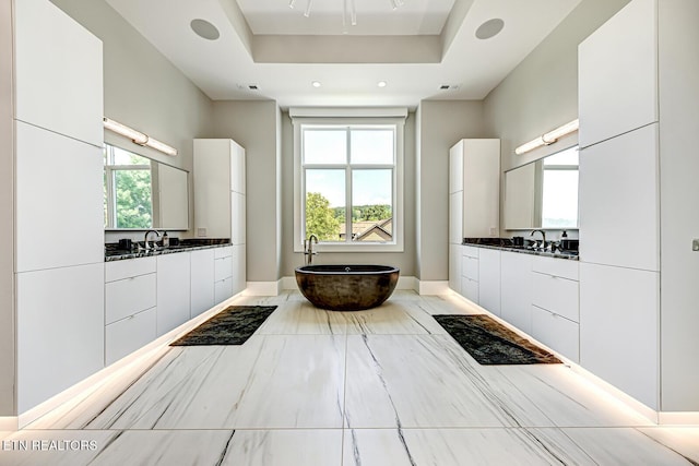 201 Crown Jewel Ln, Lafollette, TN 37766 - full bathroom featuring a freestanding tub, baseboards, two vanities, a raised ceiling, and recessed lighting