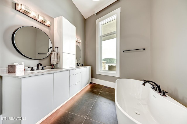 201 Crown Jewel Ln, Lafollette, TN 37766 - bathroom featuring double vanity, a freestanding tub, tile patterned floors, and baseboards