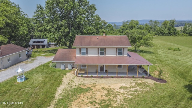 1844 Jackson Rd, Rutledge, TN 37861 - view of front facade with covered porch, a front lawn, metal roof, and driveway