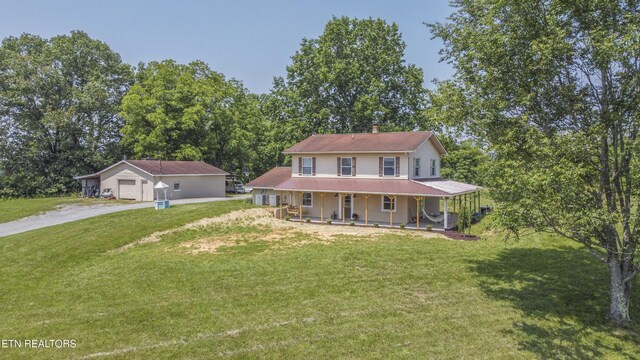1844 Jackson Rd, Rutledge, TN 37861 - country-style home with a porch, a front lawn, dirt driveway, and a garage