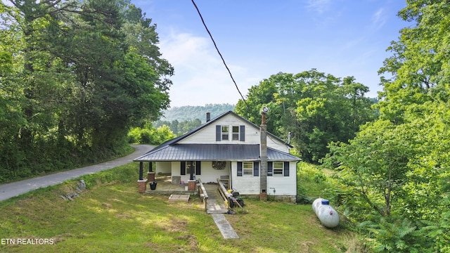 138 Bethlehem Ln, Lafollette, TN 37766 - view of front of house with covered porch, a front yard, a chimney, and metal roof