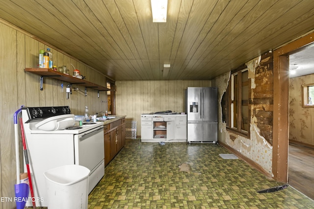 138 Bethlehem Ln, Lafollette, TN 37766 - kitchen with stainless steel fridge with ice dispenser, electric stove, open shelves, wood walls, and dark floors