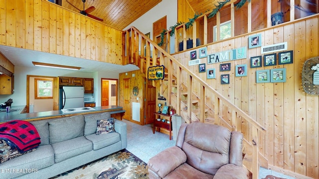 1464 Blue Mill Rd, Del Rio, TN 37727 - living room with wood walls, a towering ceiling, stairs, tile patterned floors, and wood ceiling