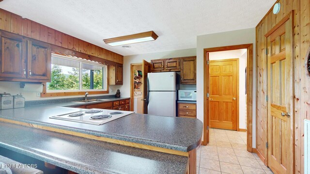 1464 Blue Mill Rd, Del Rio, TN 37727 - kitchen with white appliances, a sink, a peninsula, dark countertops, and a textured ceiling