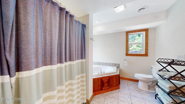 1464 Blue Mill Rd, Del Rio, TN 37727 - full bathroom featuring a bath, tile patterned floors, toilet, and baseboards