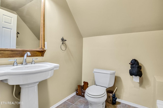 1707 Brookview Dr, Dandridge, TN 37725 - bathroom with lofted ceiling, toilet, baseboards, a sink, and tile patterned floors