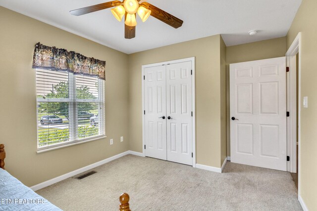 1707 Brookview Dr, Dandridge, TN 37725 - unfurnished bedroom with light carpet, a closet, a ceiling fan, and baseboards