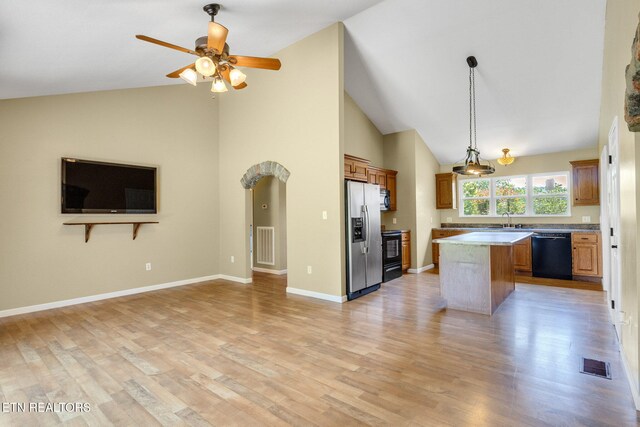 1707 Brookview Dr, Dandridge, TN 37725 - kitchen with black appliances, open floor plan, a sink, a center island, and high vaulted ceiling