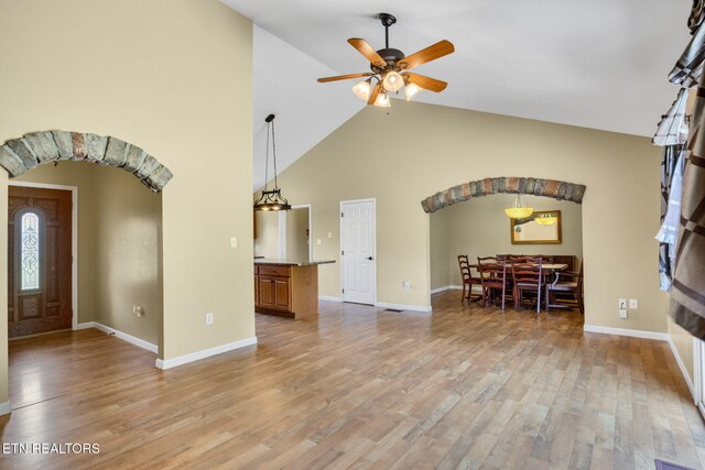 1707 Brookview Dr, Dandridge, TN 37725 - foyer entrance with arched walkways, light wood-type flooring, ceiling fan, baseboards, and high vaulted ceiling
