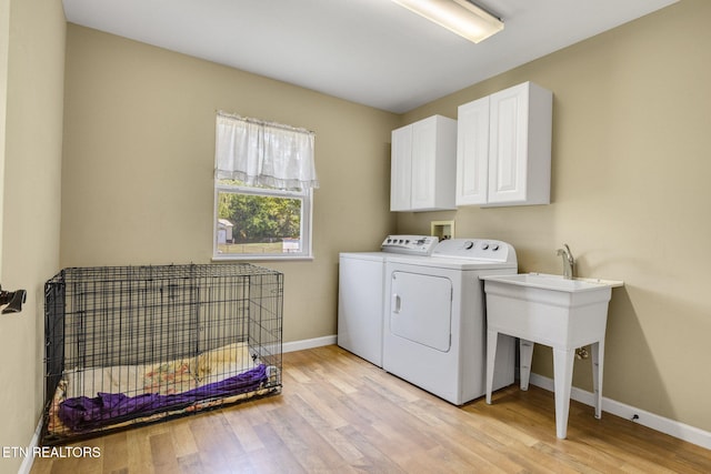 1707 Brookview Dr, Dandridge, TN 37725 - laundry area featuring independent washer and dryer, light wood-style flooring, baseboards, and cabinet space