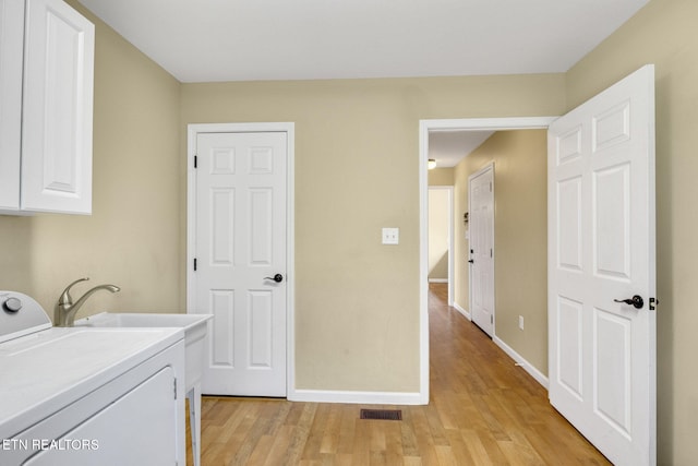 1707 Brookview Dr, Dandridge, TN 37725 - laundry area with washer / dryer, cabinet space, light wood-style flooring, and baseboards