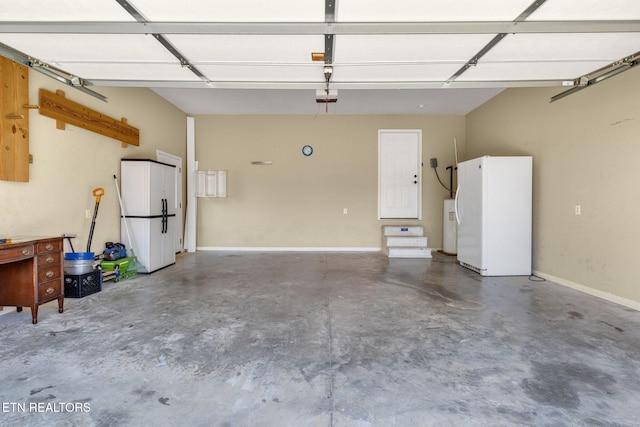 1707 Brookview Dr, Dandridge, TN 37725 - garage with freestanding refrigerator, a garage door opener, water heater, and baseboards