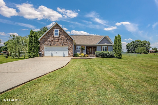 1707 Brookview Dr, Dandridge, TN 37725 - view of front facade featuring concrete driveway, a front yard, stone siding, and a garage