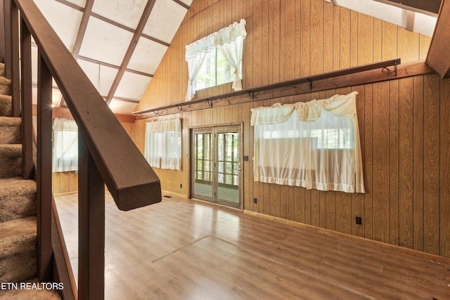 4539 Houge Way, Cosby, TN 37722 - unfurnished living room featuring wood walls, wood finished floors, stairs, and high vaulted ceiling