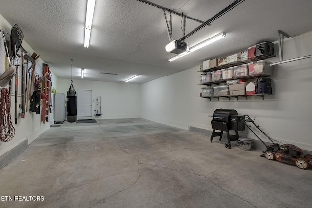 226 Oostanali Way, Loudon, TN 37774 - garage featuring a garage door opener and baseboards