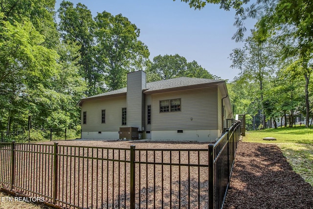 226 Oostanali Way, Loudon, TN 37774 - back of house with crawl space, roof with shingles, a chimney, and view of wooded area