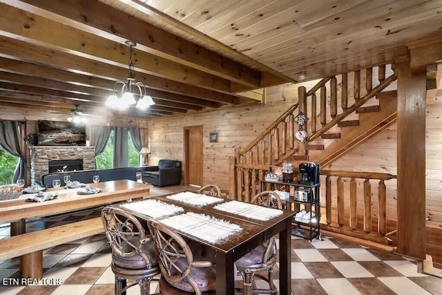 1056 Black Bear Cub Way, Sevierville, TN 37862 - dining space with wooden walls, a fireplace, a ceiling fan, stairway, and tile patterned floors