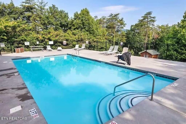 1056 Black Bear Cub Way, Sevierville, TN 37862 - community pool featuring a patio and view of wooded area