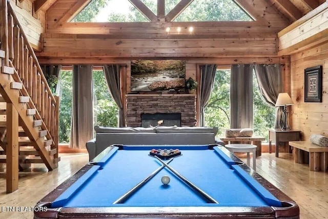 1056 Black Bear Cub Way, Sevierville, TN 37862 - recreation room with wood walls, healthy amount of natural light, pool table, high vaulted ceiling, and a stone fireplace