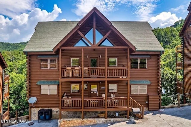 1056 Black Bear Cub Way, Sevierville, TN 37862 - view of front of home with a balcony, log siding, and roof with shingles