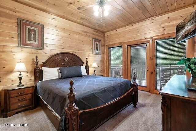 1056 Black Bear Cub Way, Sevierville, TN 37862 - bedroom with light carpet, access to exterior, wooden ceiling, and wood walls