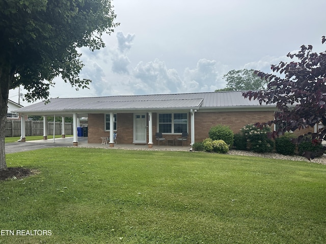 2605 Mountain View Dr, Morristown, TN 37814 - ranch-style house featuring brick siding, a carport, metal roof, driveway, and covered porch