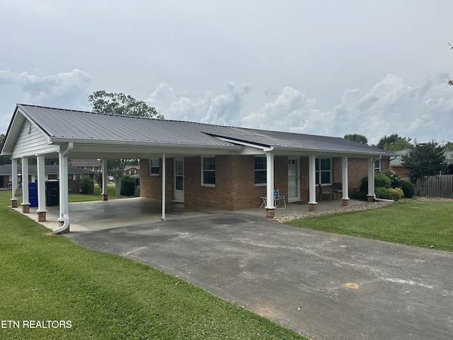 2605 Mountain View Dr, Morristown, TN 37814 - single story home with driveway, an attached carport, brick siding, covered porch, and metal roof
