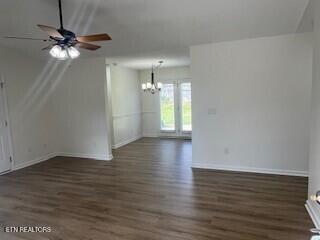 6206 Jim Fox Ln, Powell, TN 37849 - unfurnished living room featuring a chandelier, wood finished floors, ceiling fan, and baseboards