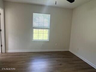 6206 Jim Fox Ln, Powell, TN 37849 - unfurnished room featuring wood finished floors, a ceiling fan, and baseboards