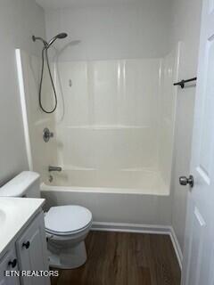 6206 Jim Fox Ln, Powell, TN 37849 - full bath with wood finished floors, vanity, bathtub / shower combination, and toilet