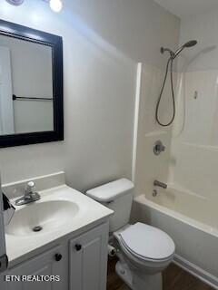 6206 Jim Fox Ln, Powell, TN 37849 - bathroom with vanity, toilet, tub / shower combination, and wood finished floors