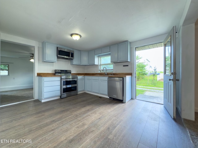 104 Church St, Loudon, TN 37774 - kitchen with stainless steel appliances, wood counters, and light wood-type flooring